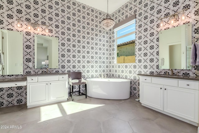 bathroom featuring tile patterned floors, a tub to relax in, and vanity