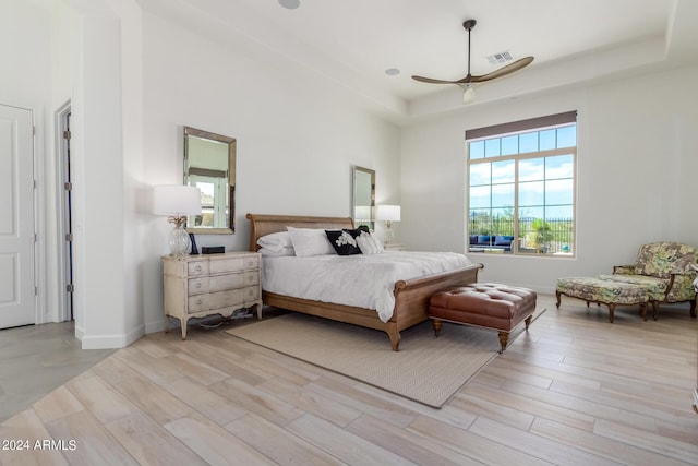 bedroom featuring ceiling fan and a raised ceiling