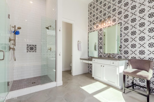 bathroom featuring vanity, toilet, and an enclosed shower