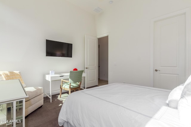 bedroom featuring dark carpet