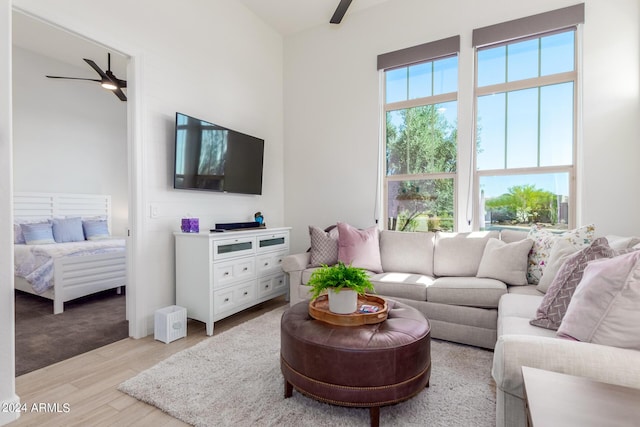 living room featuring ceiling fan and light hardwood / wood-style floors