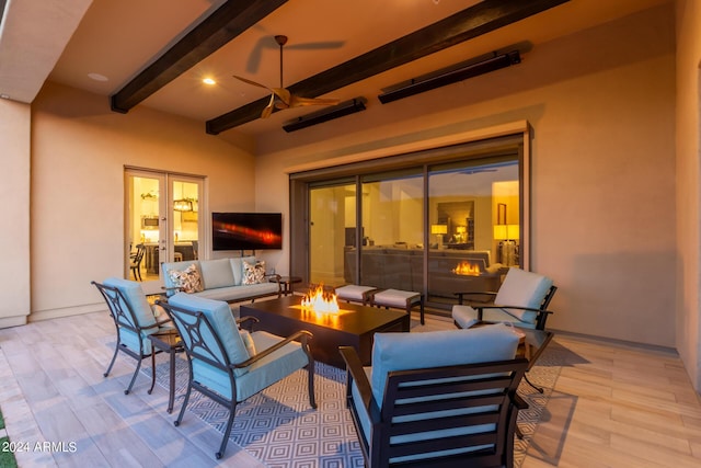 view of patio with an outdoor living space with a fire pit