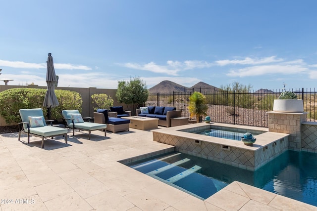 view of swimming pool with an in ground hot tub, an outdoor hangout area, and a patio