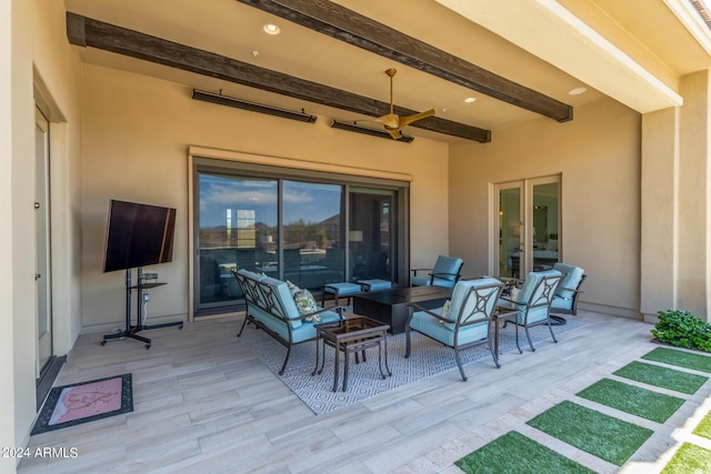 view of patio with an outdoor living space with a fire pit