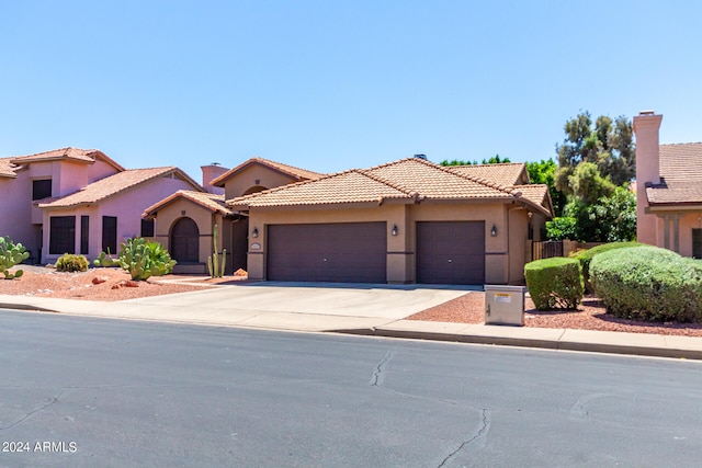 mediterranean / spanish-style house with a garage