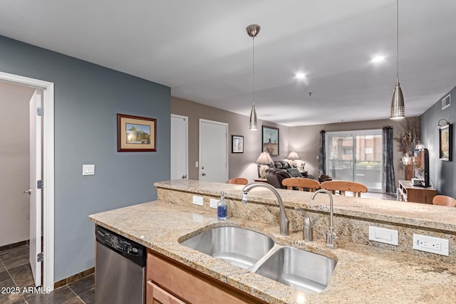 kitchen featuring visible vents, dishwasher, open floor plan, decorative light fixtures, and a sink