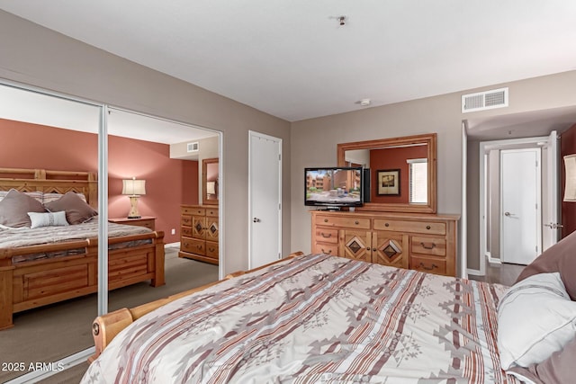 carpeted bedroom featuring visible vents