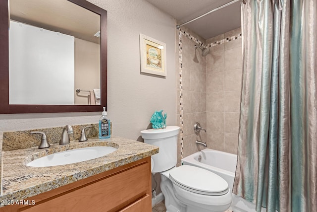 bathroom featuring toilet, a textured wall, shower / tub combo, and vanity