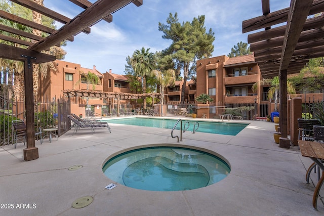 pool with a hot tub, a patio, a residential view, fence, and a pergola