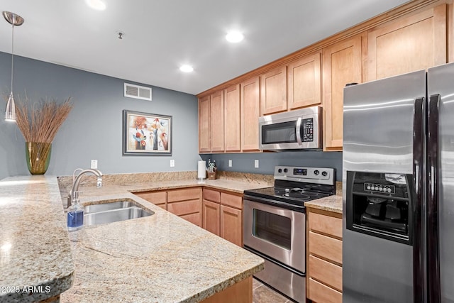 kitchen with stainless steel appliances, visible vents, light brown cabinets, a sink, and a peninsula