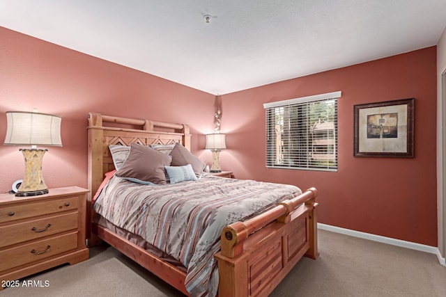 bedroom featuring light colored carpet and baseboards