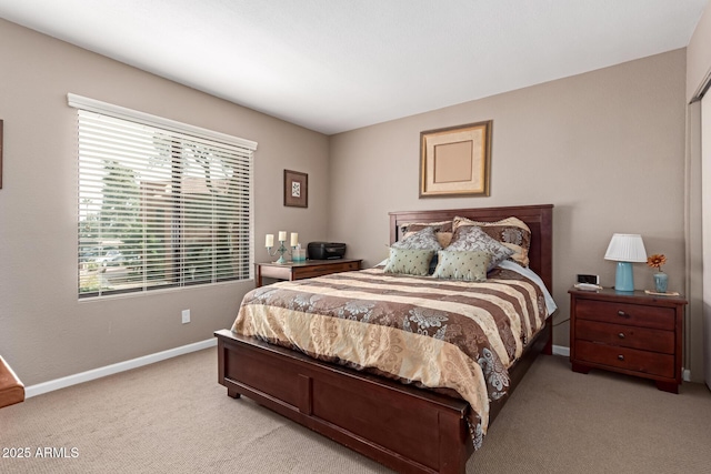 bedroom with light carpet and baseboards