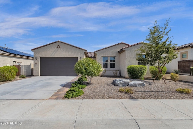 view of front of house with a garage and solar panels