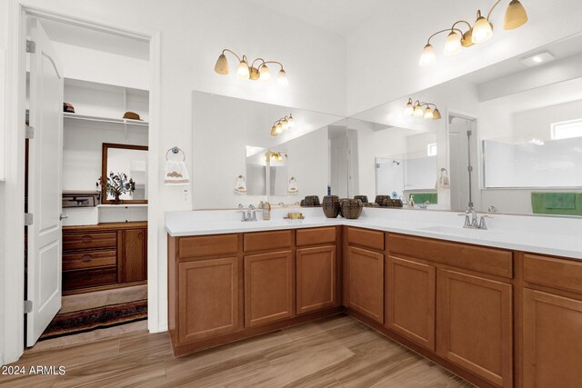 bathroom featuring dual vanity and hardwood / wood-style floors