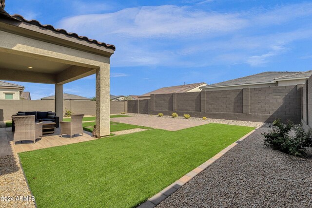 view of yard with an outdoor living space and a patio