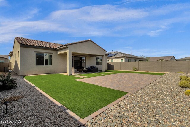 rear view of house with a patio, central AC, and a lawn