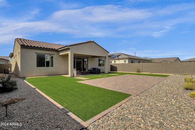 rear view of house with a patio, a yard, and central air condition unit