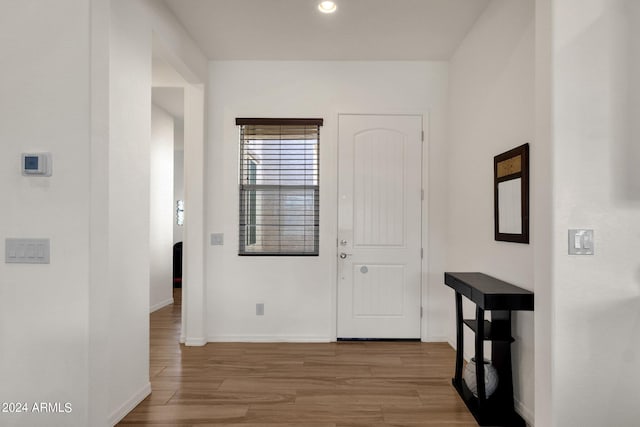 hallway with hardwood / wood-style flooring