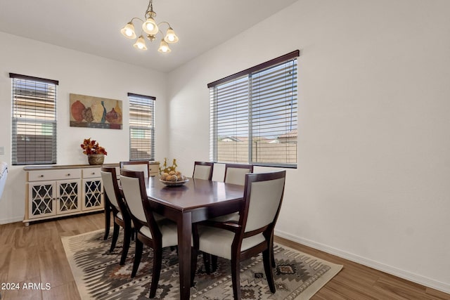 dining space featuring an inviting chandelier and hardwood / wood-style flooring