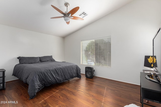 bedroom with ceiling fan, dark hardwood / wood-style flooring, and vaulted ceiling