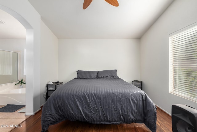 bedroom with dark hardwood / wood-style flooring and ceiling fan