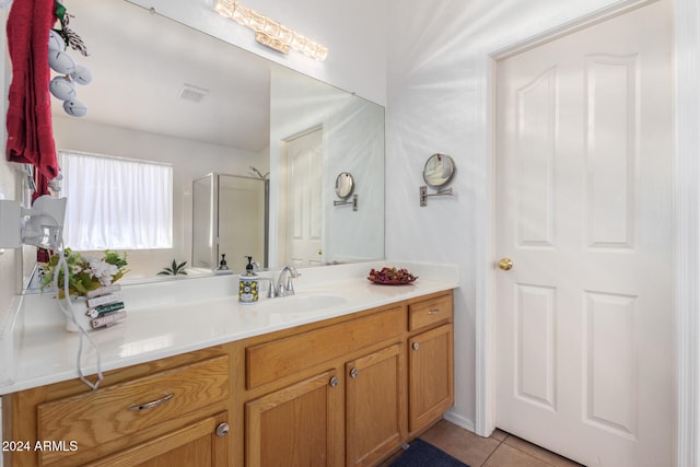 bathroom featuring tile patterned floors, vanity, and an enclosed shower