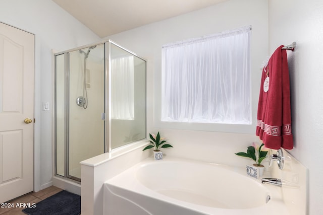 bathroom featuring tile patterned flooring and independent shower and bath