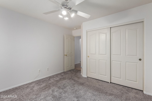 unfurnished bedroom featuring light carpet, a closet, and ceiling fan