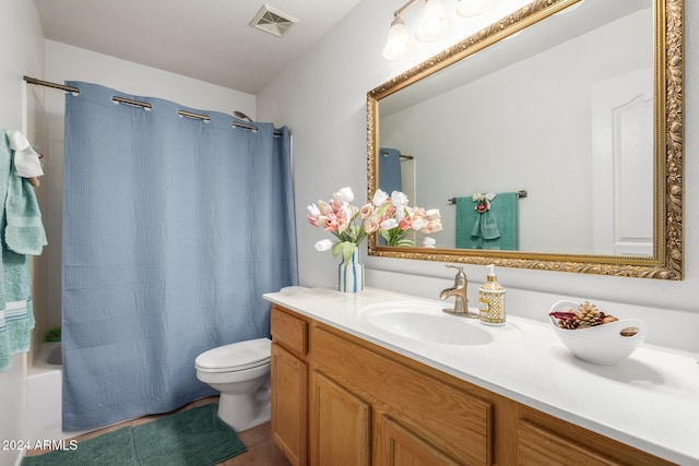 full bathroom featuring tile patterned floors, vanity, toilet, and shower / bath combo with shower curtain