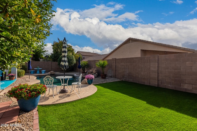 view of yard with a patio area and a fenced in pool