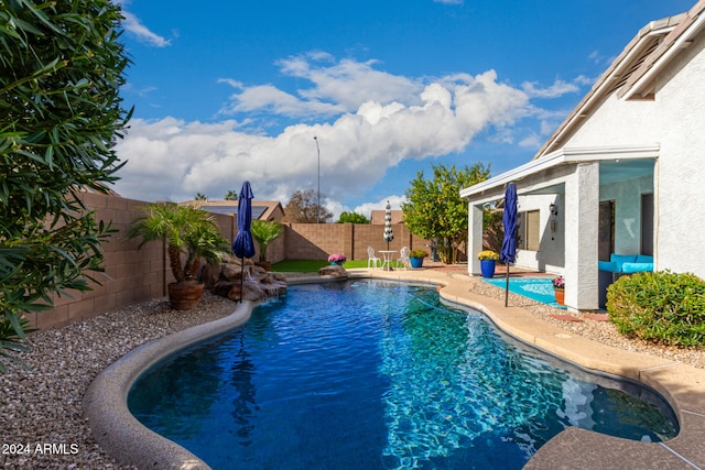 view of pool with pool water feature and a patio