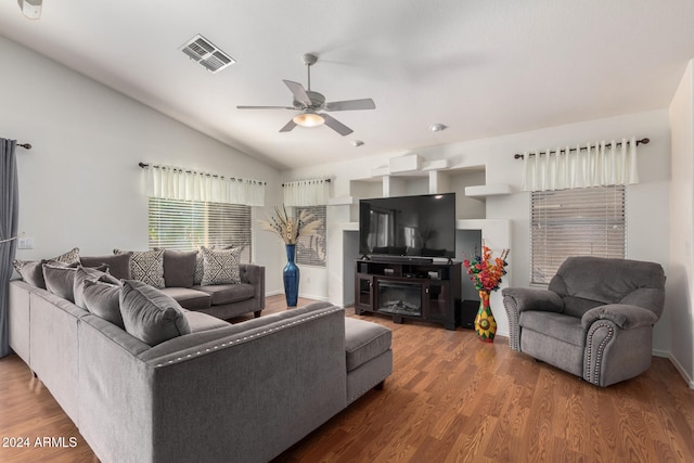 living room featuring dark hardwood / wood-style flooring, ceiling fan, and lofted ceiling