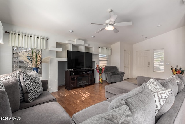 living room featuring hardwood / wood-style flooring, vaulted ceiling, and ceiling fan