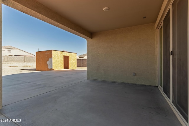 view of patio featuring a shed