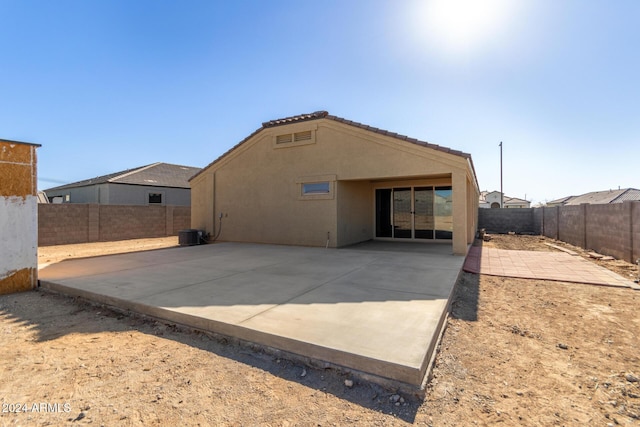 rear view of property featuring a patio area and central AC