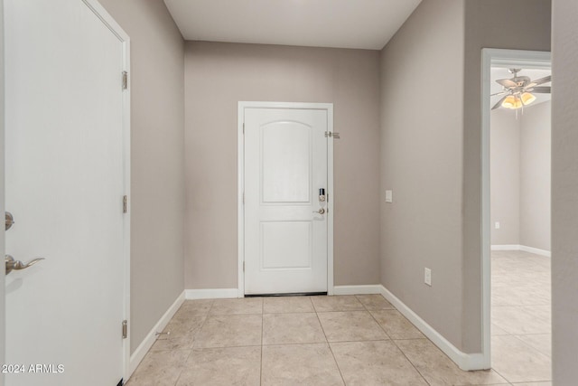 tiled entryway featuring ceiling fan