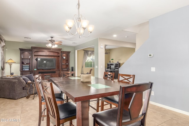 dining room with ceiling fan with notable chandelier and light tile patterned floors