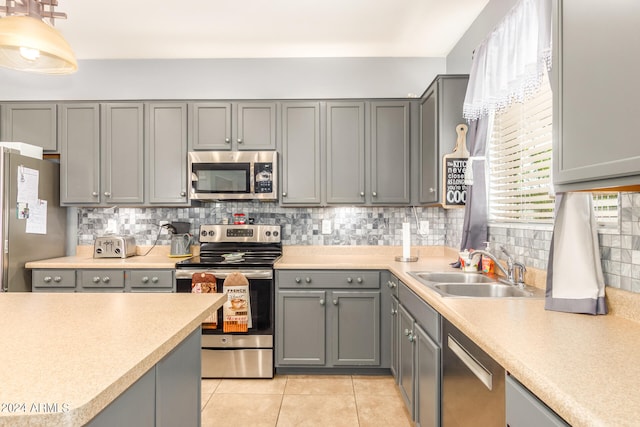 kitchen with appliances with stainless steel finishes and gray cabinetry