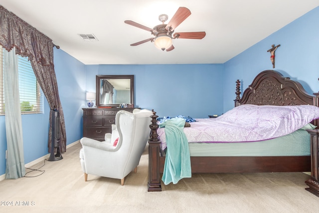 bedroom featuring ceiling fan and light carpet