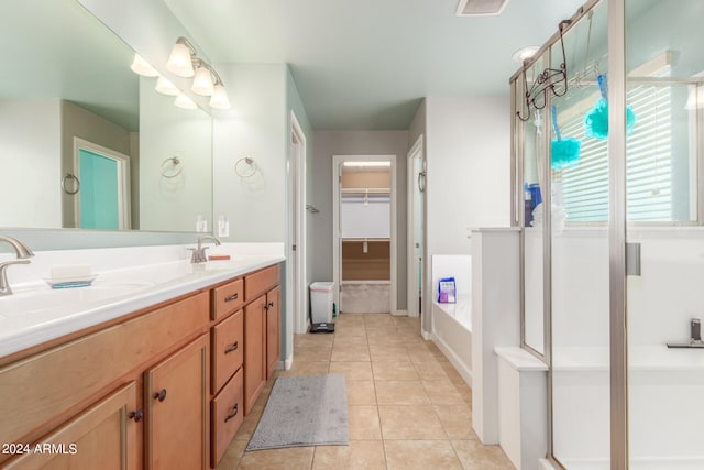 bathroom with tile patterned floors, vanity, and independent shower and bath