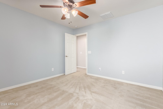 carpeted spare room with ceiling fan