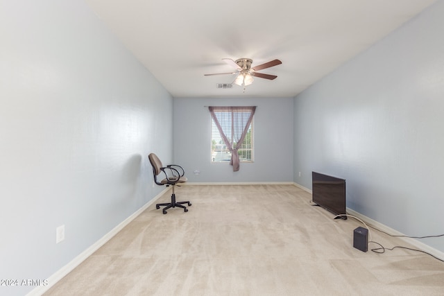 interior space with ceiling fan and light colored carpet