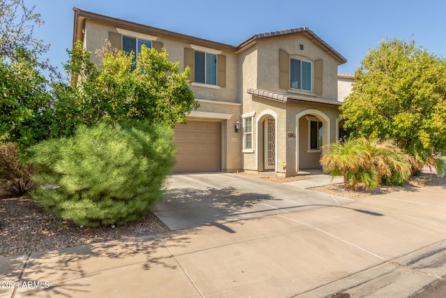 mediterranean / spanish-style home featuring a garage