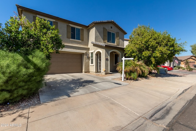 mediterranean / spanish-style home with a garage