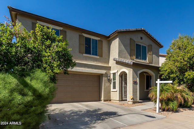 mediterranean / spanish-style house with a garage