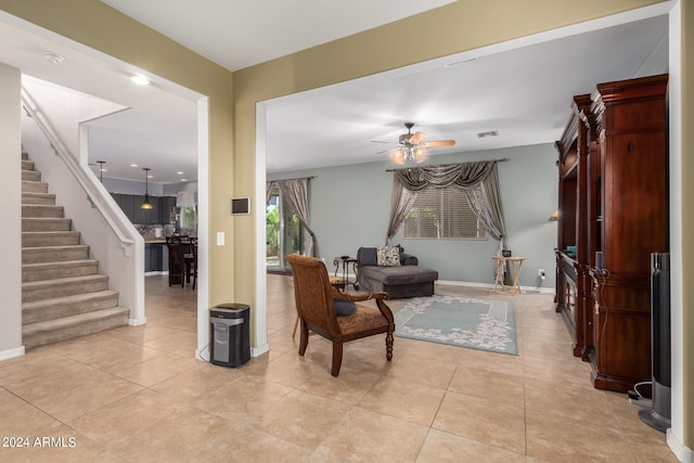 living area featuring ceiling fan and light tile patterned floors