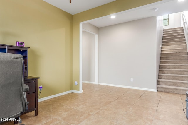 unfurnished office with light tile patterned floors