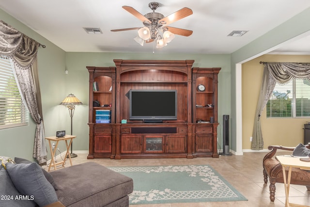 tiled living room featuring ceiling fan and a healthy amount of sunlight