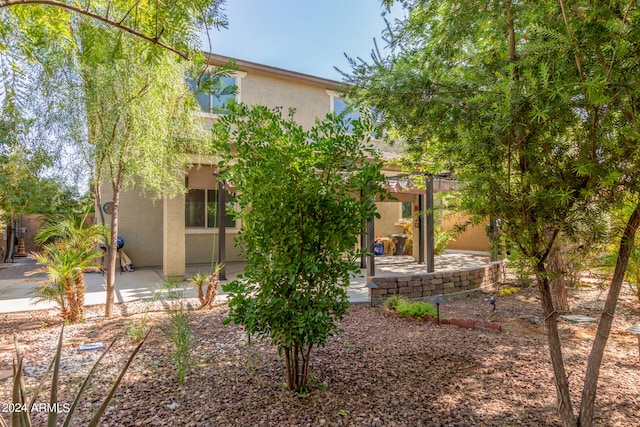 back of house with a patio