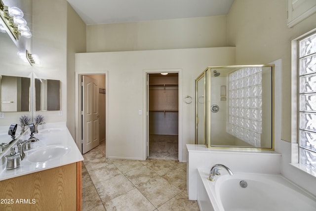 full bathroom with a garden tub, a sink, a stall shower, and a healthy amount of sunlight